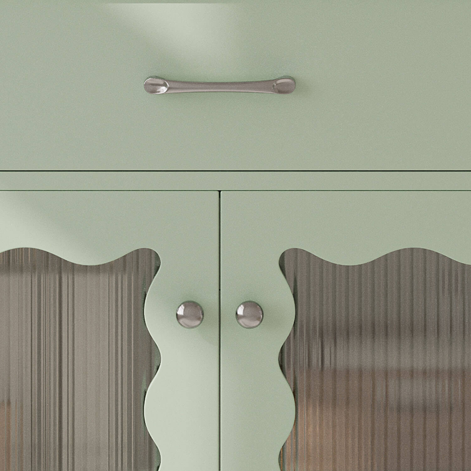 close up of silver handle on light green bathroom vanity cabinet