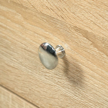polished silver chrome drawer knob detail on natural oak wood bathroom vanity cabinet