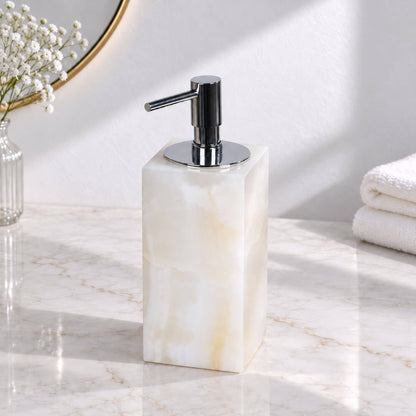 White jade marble lotion and soap dispenser with polished chrome pump on a bathroom vanity