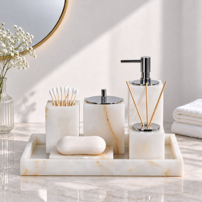 White marble bathroom accessory set with soap dispenser, storage jars and tray, front view