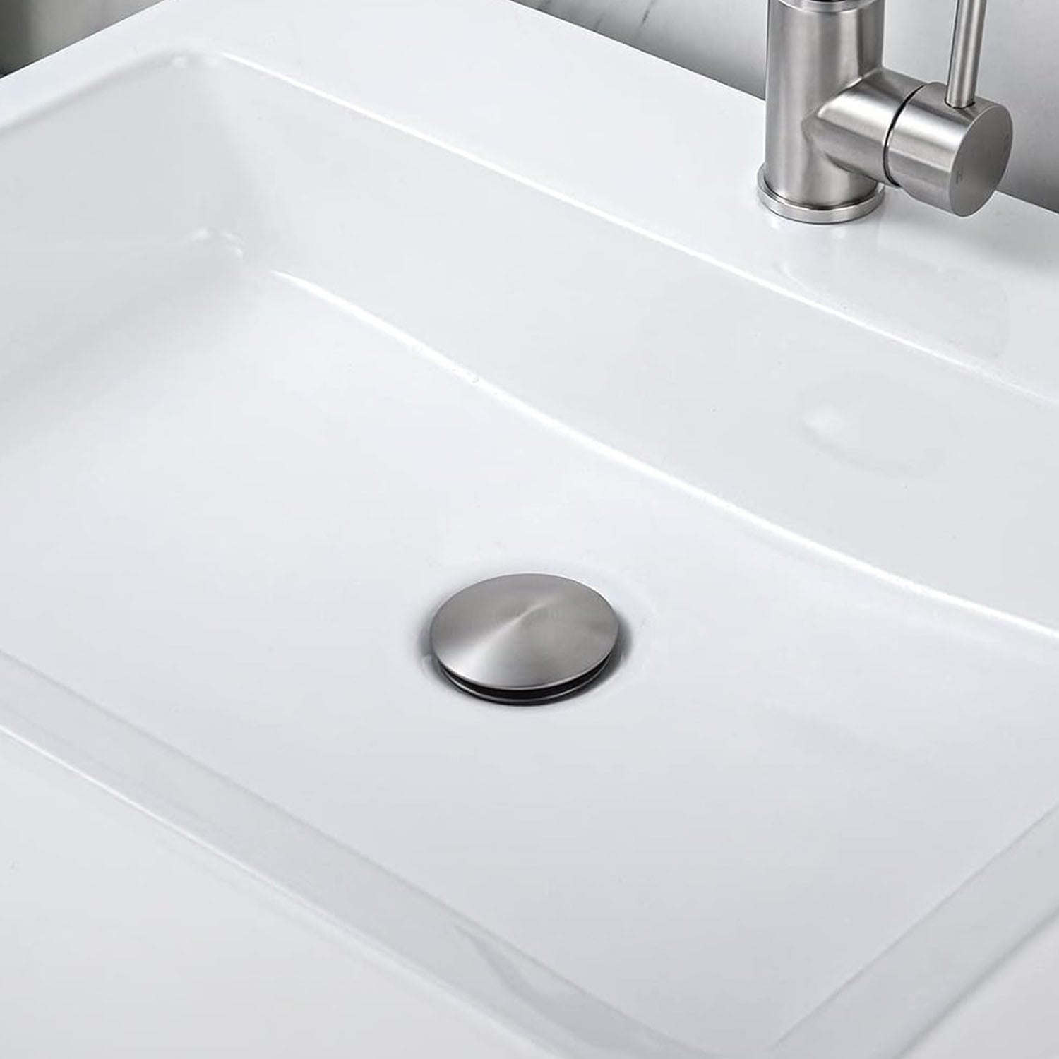 white sink with a Brushed Nickel Bathroom Sink Pop Up Drain