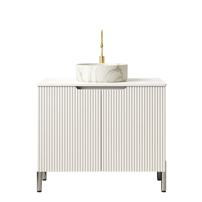 white vanity cabinet with fluted textured door panels